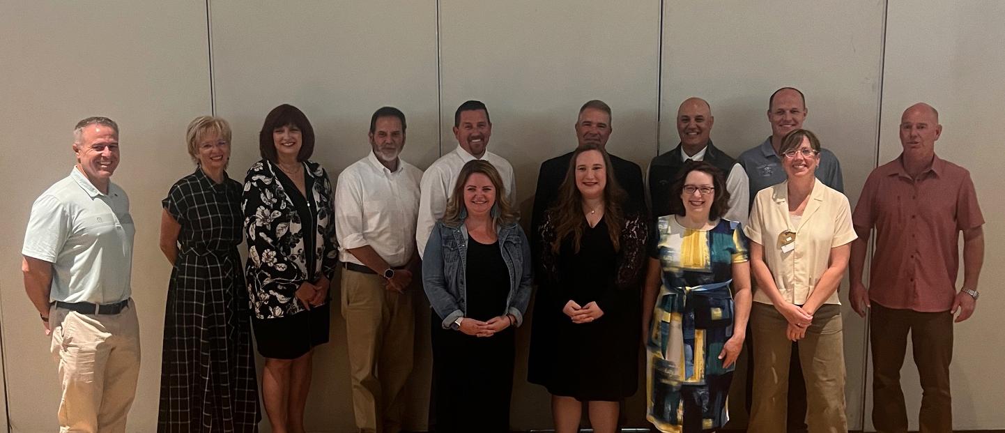 A group of teachers and administrators pose together at the educator of the year awards. Beth Dunn stands second from the right. 